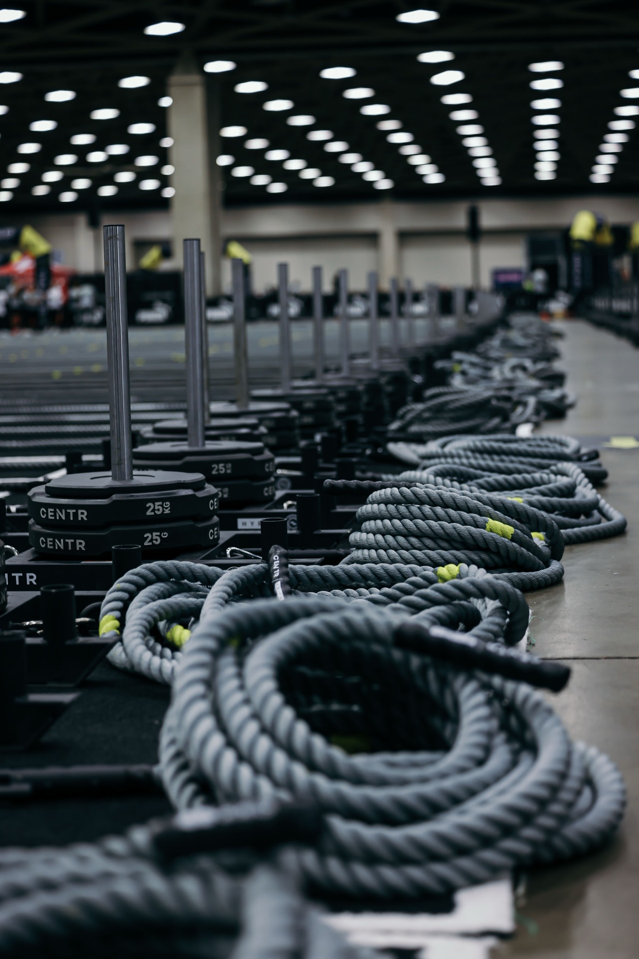 HYROX event floor with sleds and battle ropes